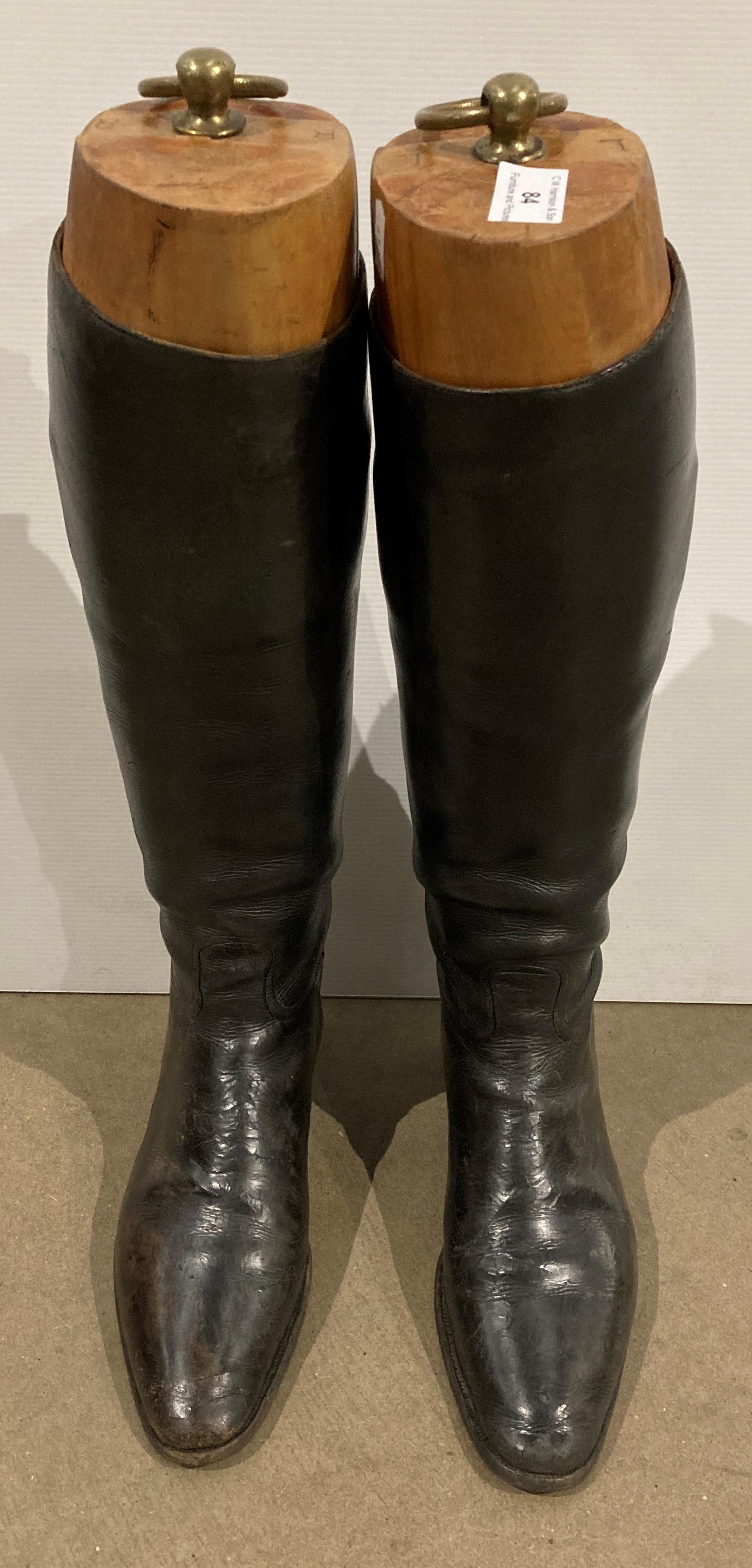 Pair of dark brown leather riding boots (possibly size 6 or 7) and a pair of wooden boot stretchers