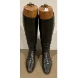 Pair of dark brown leather riding boots (possibly size 6 or 7) and a pair of wooden boot stretchers