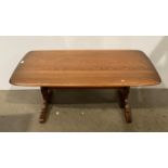 An Ercol medium elm coffee table with centre stretcher 70cm x 130cm (saleroom location: S2)