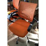 An orange mesh seat and back operators swivel armchair (saleroom location: main area)