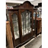 Mahogany glass fronted single door glass shelved china cabinet on claw and ball feet with arched