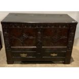 An 18th century carved dark oak mule chest with two drawers (missing bottom lining) (saleroom
