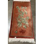 A dusky pink dragon motif Chinese rug approx.