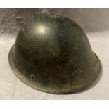 A black metal military helmet