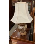 A beige patterned table lamp with shade,