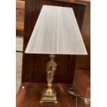 A brass table lamp complete with shade
