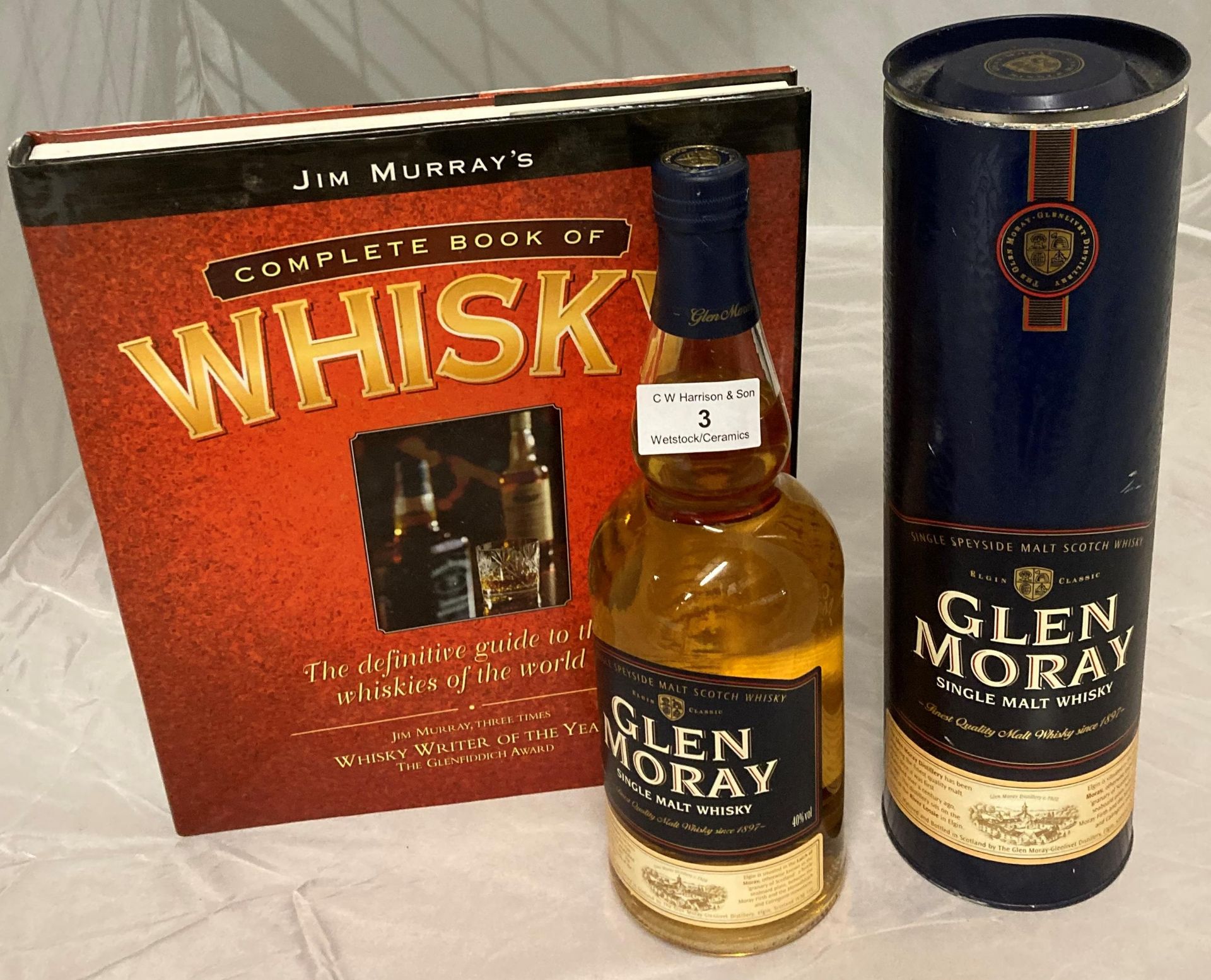 A 70cl bottle of Glen Moray Single Malt Whisky 40% volume in presentation canister and Jim Murray's