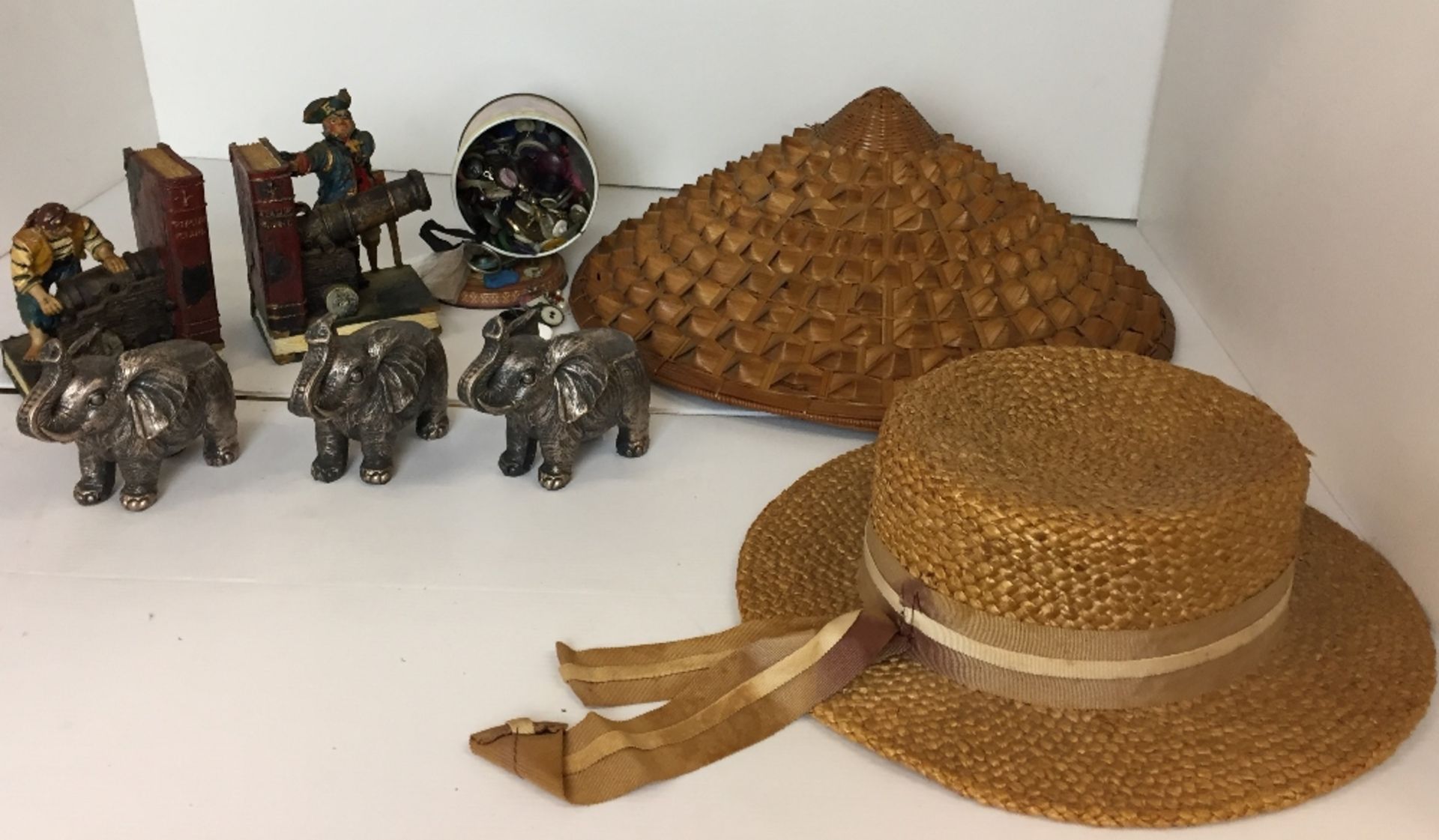 Five items - straw boater, Chinese bamboo coolie hat, pair of Treasure Island book ends,