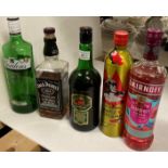 Five items - part bottles including Jack Daniels Tennessee whisky, Smirnoff Raspberry Crush vodka,