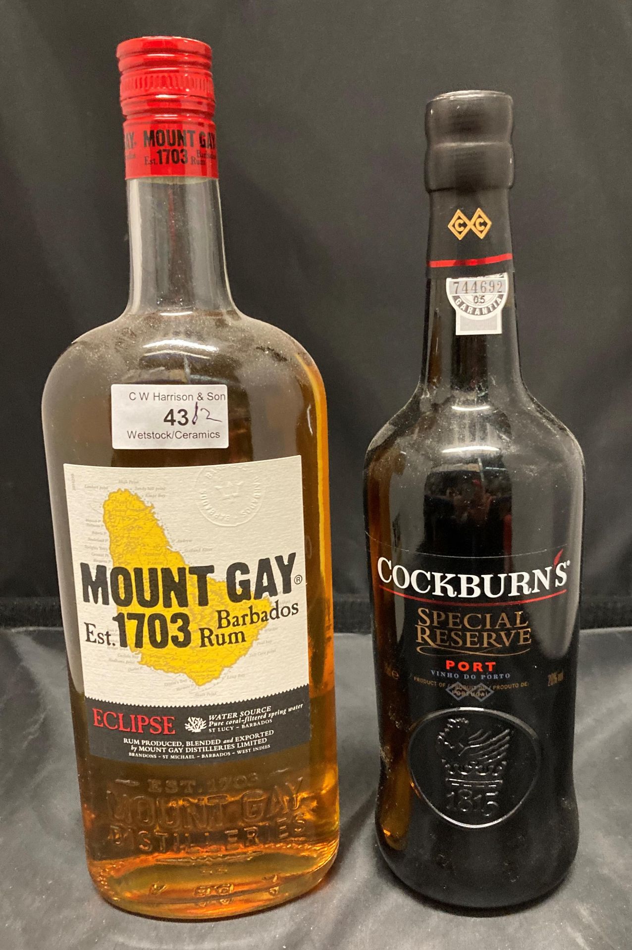 A one litre bottle of Eclipse Mount Gay Barbados Rum 40% volume and a 75cl bottle of Cockburn's