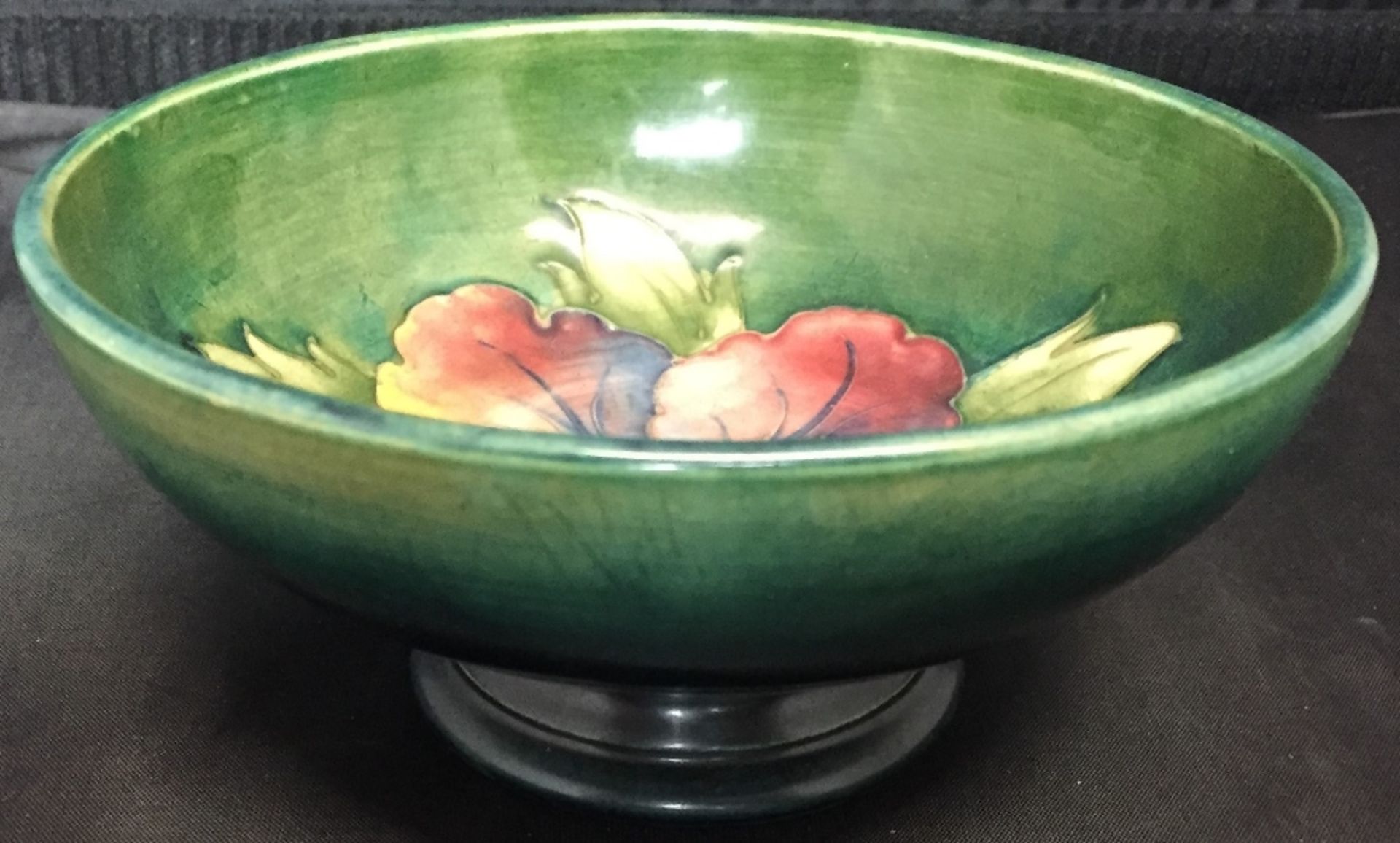 A Moorcroft green glazed Hibiscus pattern dish 14cm diameter (saleroom location: V12)