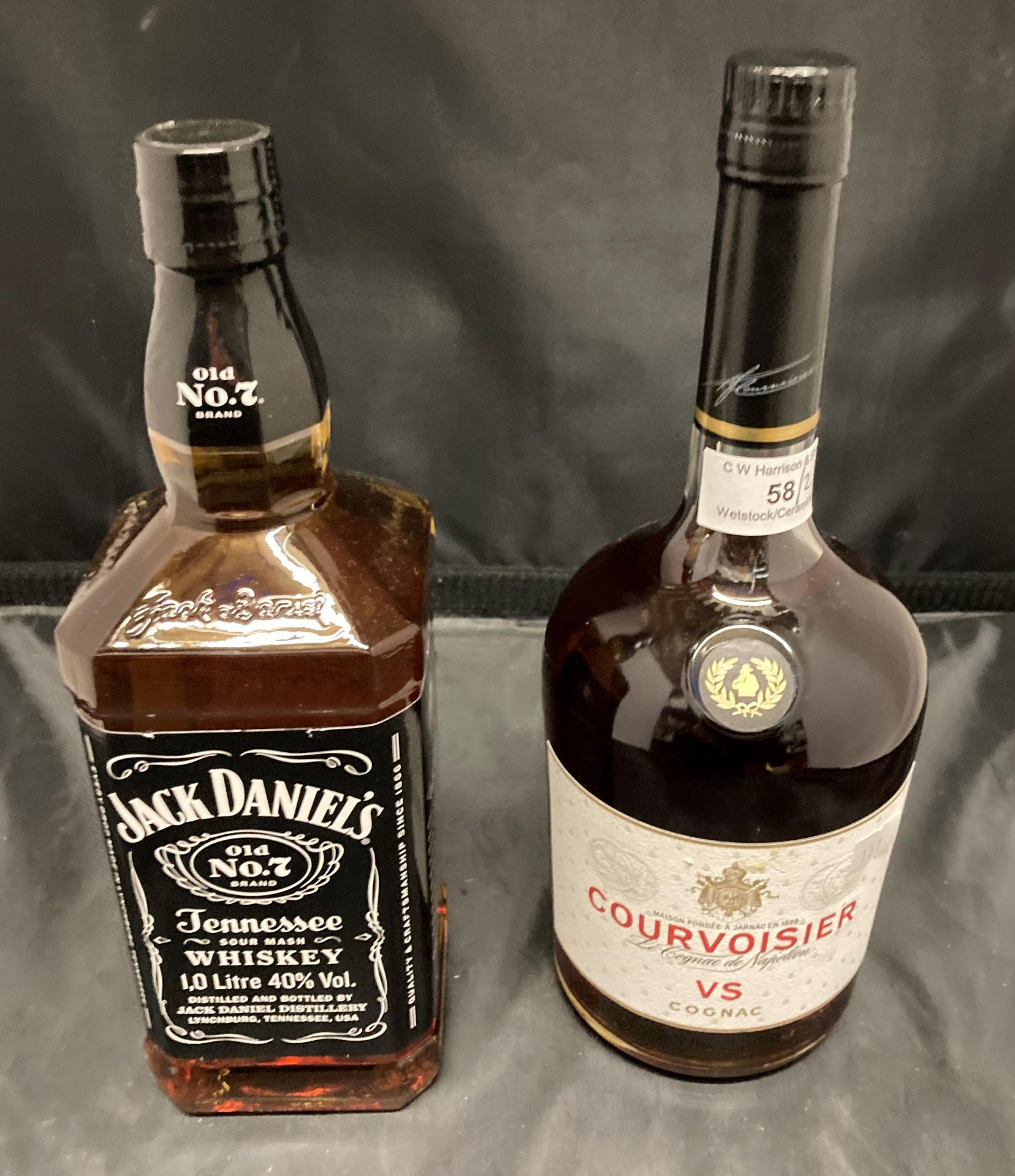 A one litre bottle of Courvoisier Cognac 40% volume and a one litre bottle of Jack Daniels Old No 7