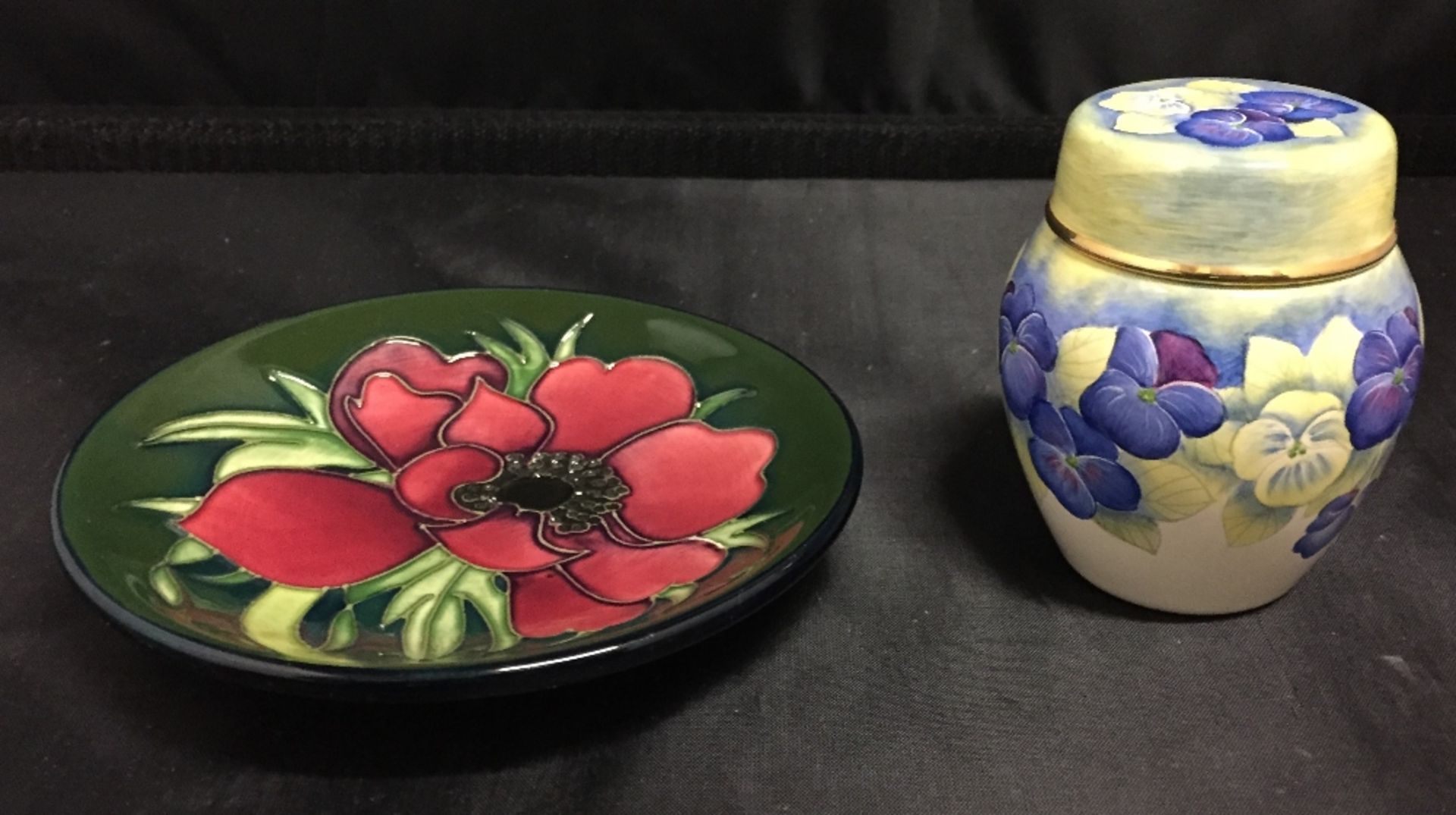 Two pieces of Moorcroft - green base small plate 12cm diameter and lidded Anemone jar 7cm high
