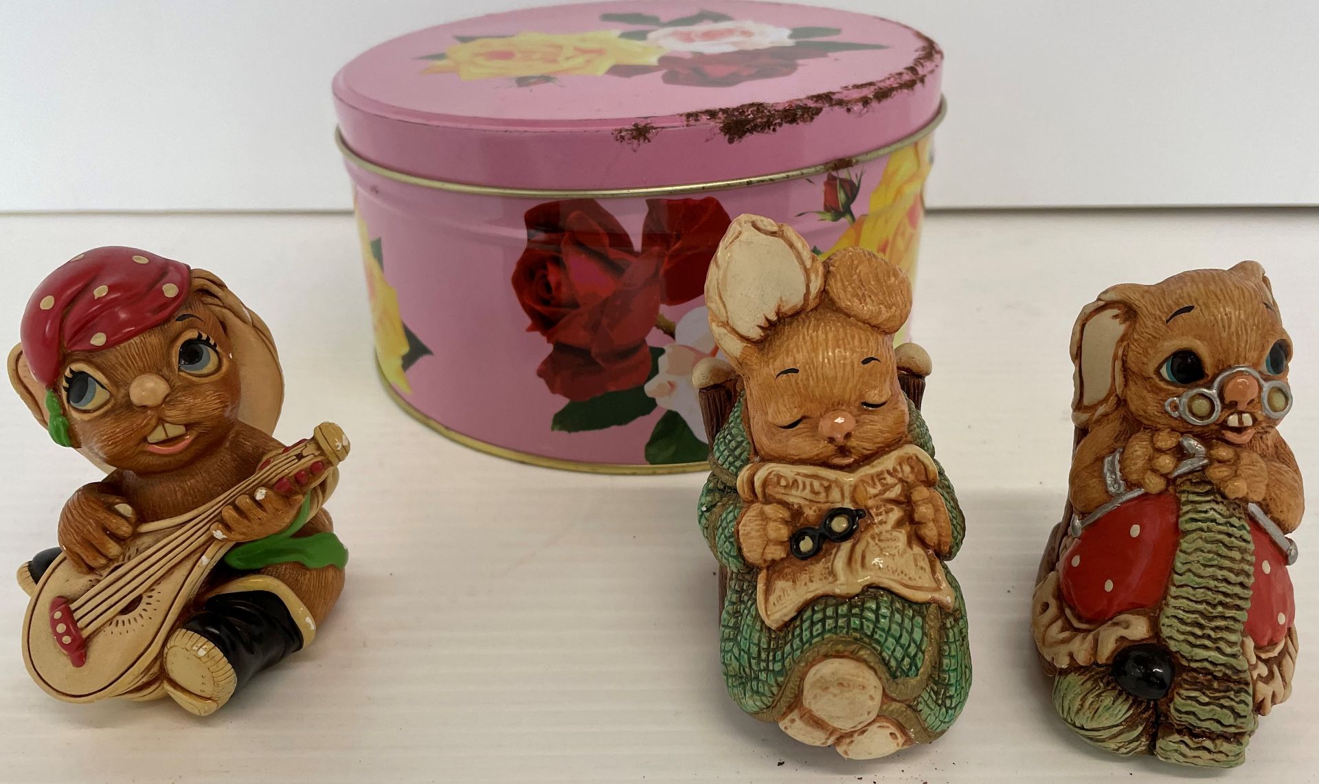 Tin containing three PenDelfin ceramic figures -Casanova and Woodlander Grandad and Nannette