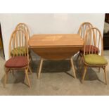Ercol medium elm and beech oval drop leaf dining table and four chairs from Originals Collection