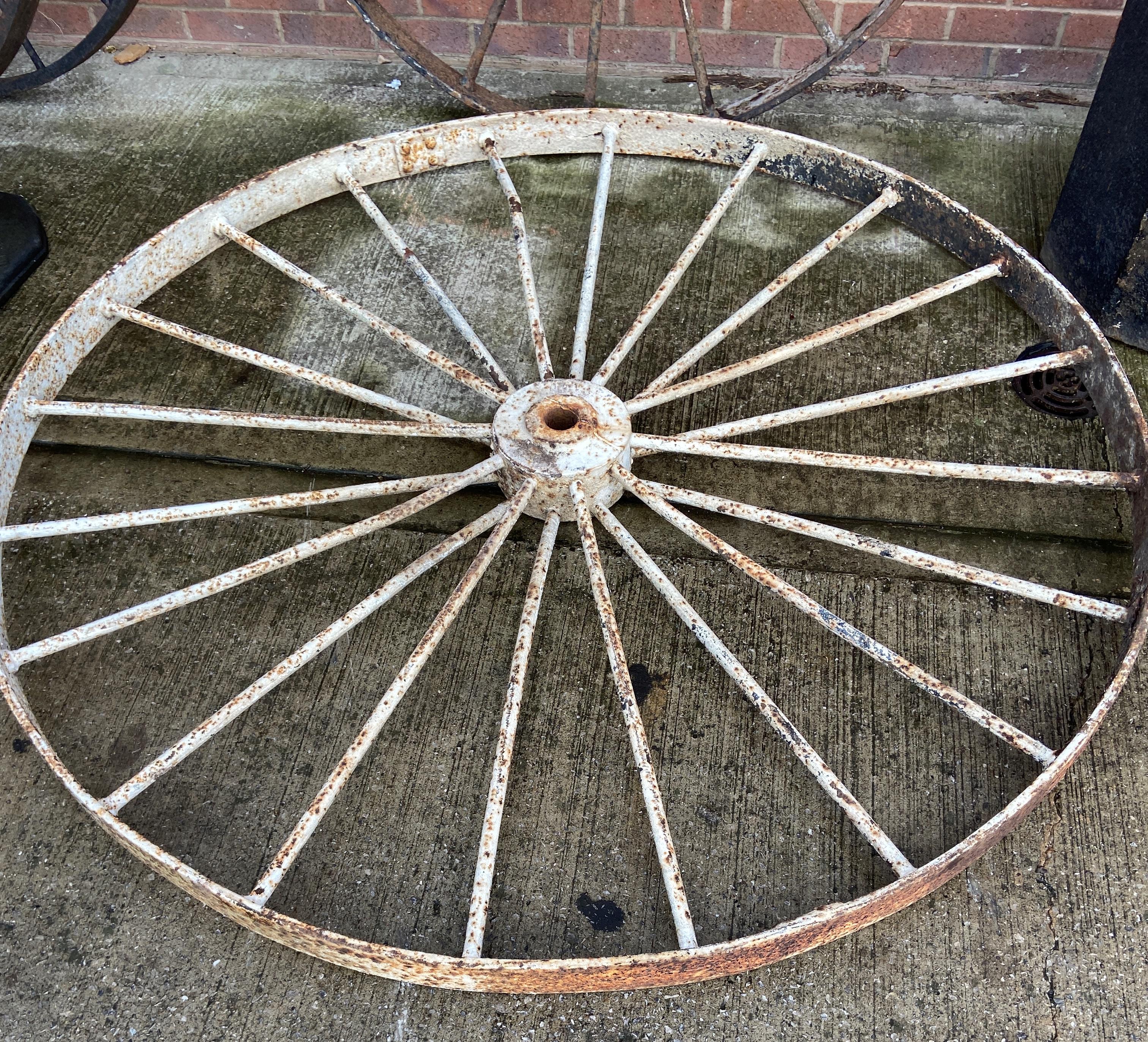A large cast metal 20 spoke wheel,