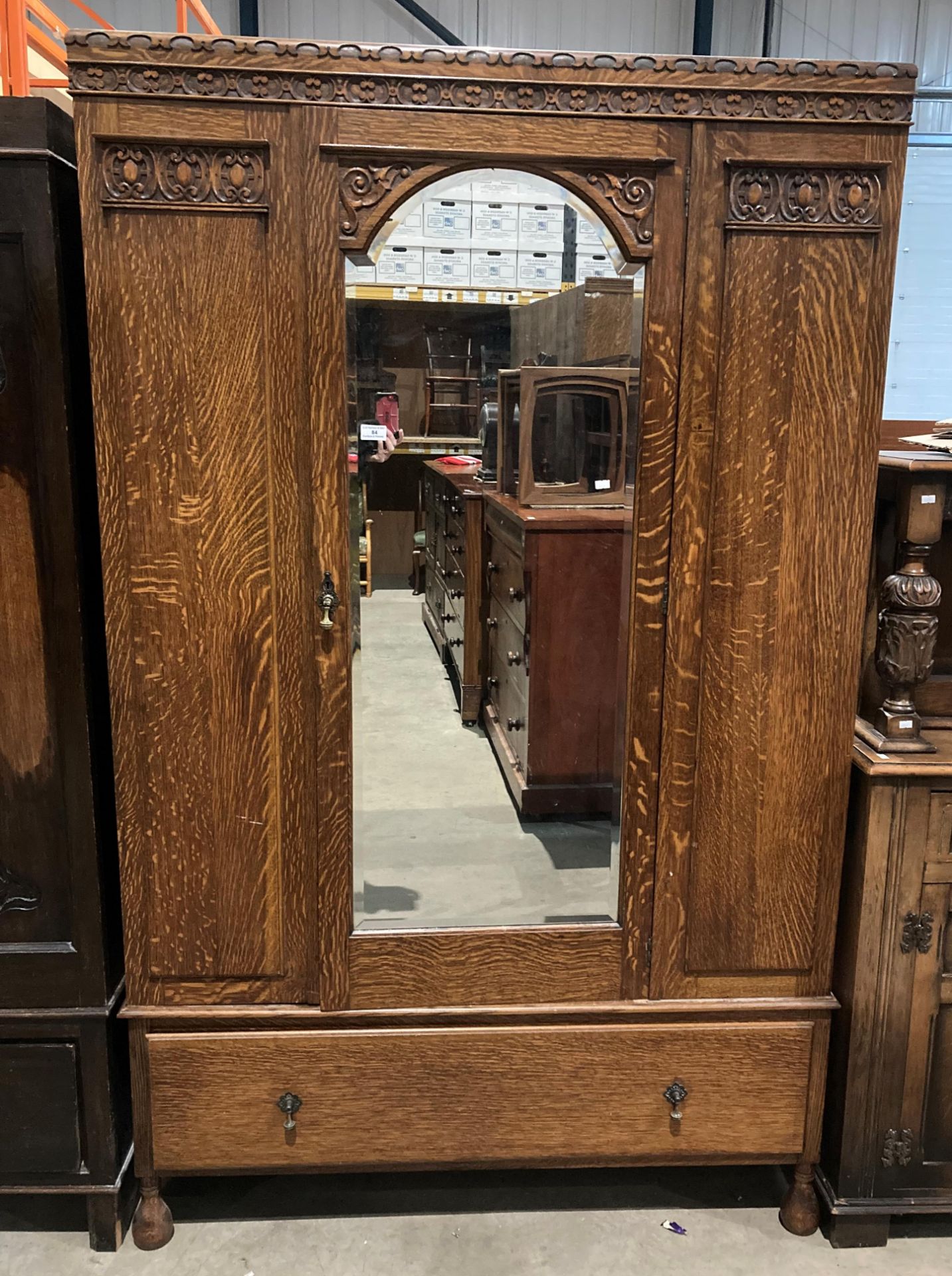An oak centre mirror door wardrobe with under drawer,