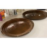 Two large engraved copper trays each 53cm dia (saleroom location: Y05)