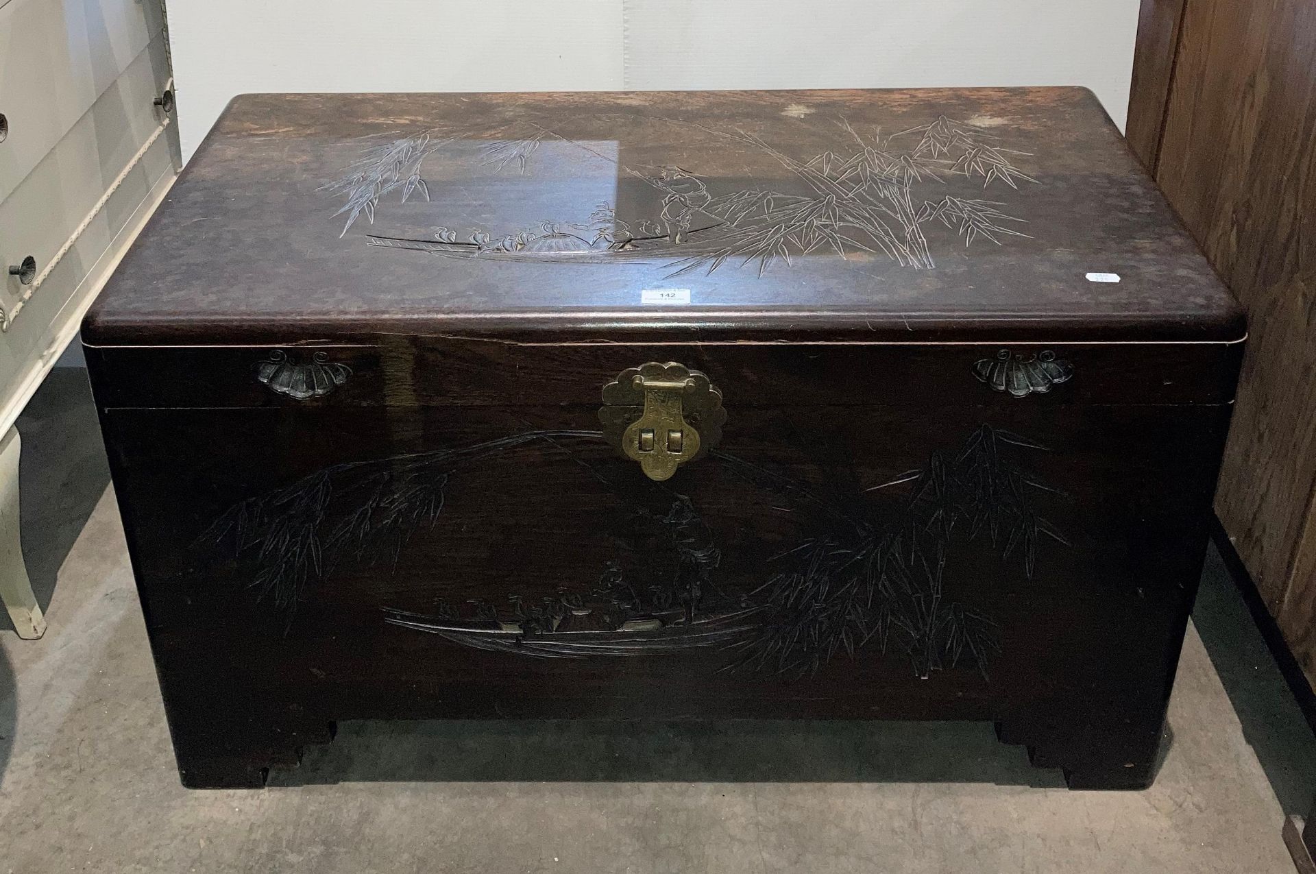 Oriental carved camphor chest with fishing scene,