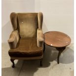 A brown dralon wing back armchair [Please note - the upholstery in this lot does not comply with