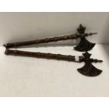 A pair of decorative reproduction axes with cast metal heads,