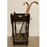 A square carved oak umbrella stand with two walking sticks (saleroom location: kit)