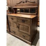 Oak dresser with short raised mirror back, with single shelf over two short drawers,