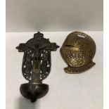 Brass plaque of a medieval knights helmet and a metal wall plaque of Jesus on a cross (saleroom