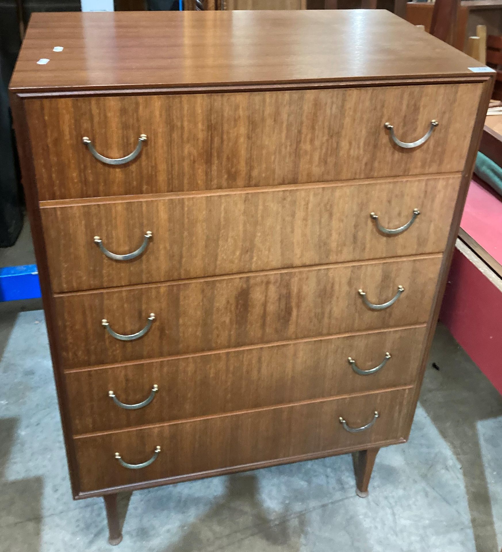 A Meredew five drawer chest of drawers in teak finish - 77 x 46 x 110cm high (saleroom location: