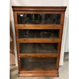 Mahogany four section glass fronted bookcase with lift up doors in the style of Globe Wernicke, 137.