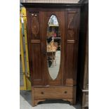 An Edwardian inlaid mahogany wardrobe with central oval mirrored door and long base drawer 189 x