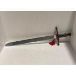 Decorative reproduction cast metal sword depicting a lions head on handle,