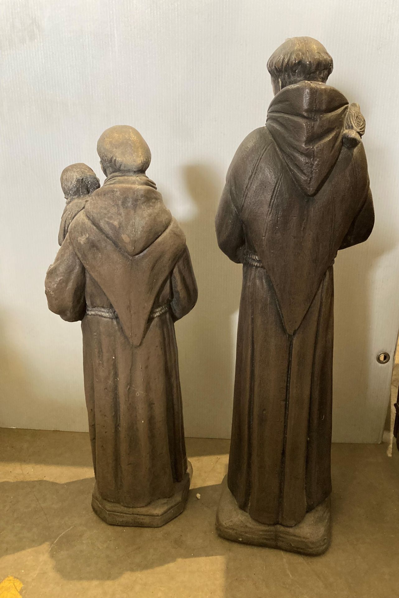 Two concrete statues of monks, one holding a dove, 75cm high and one holding a young child, - Image 2 of 2