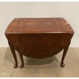 Burr walnut oval drop lead dining table,