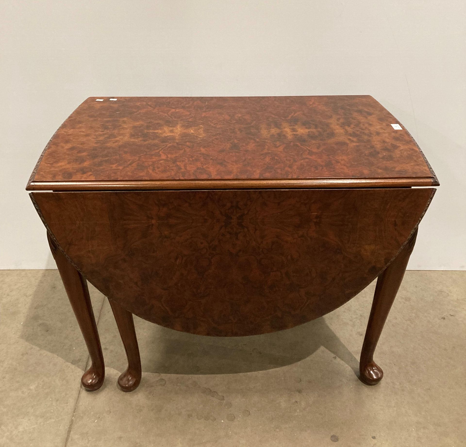 Burr walnut oval drop lead dining table,