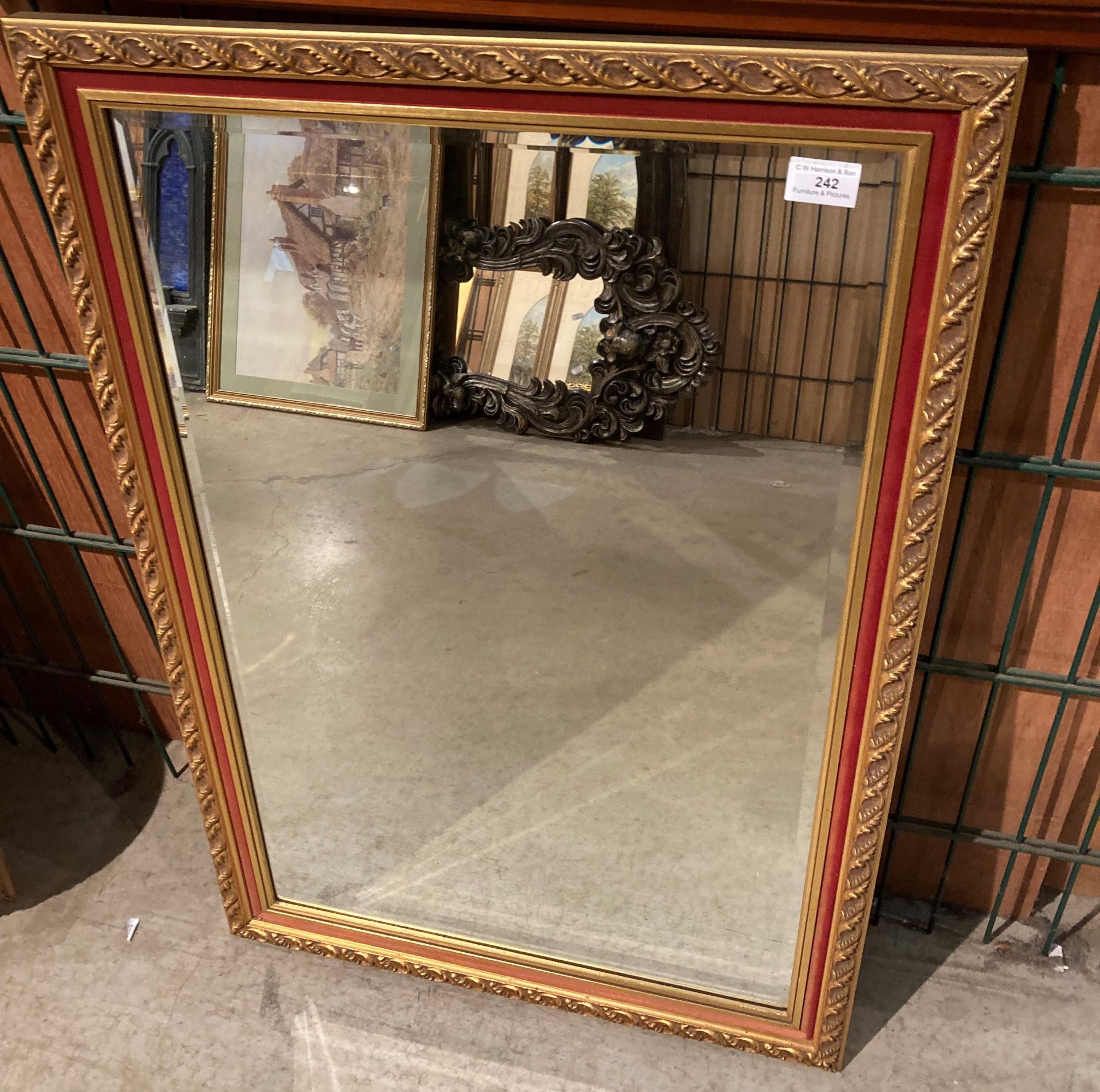 An Apex gilt red framed wall mirror,