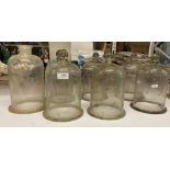 Seven smaller bell shaped glass cloches (one with open top) all approx.