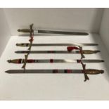 Five metal decorative swords with brass handles,