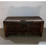Rustic oak carved front lift top coffer,