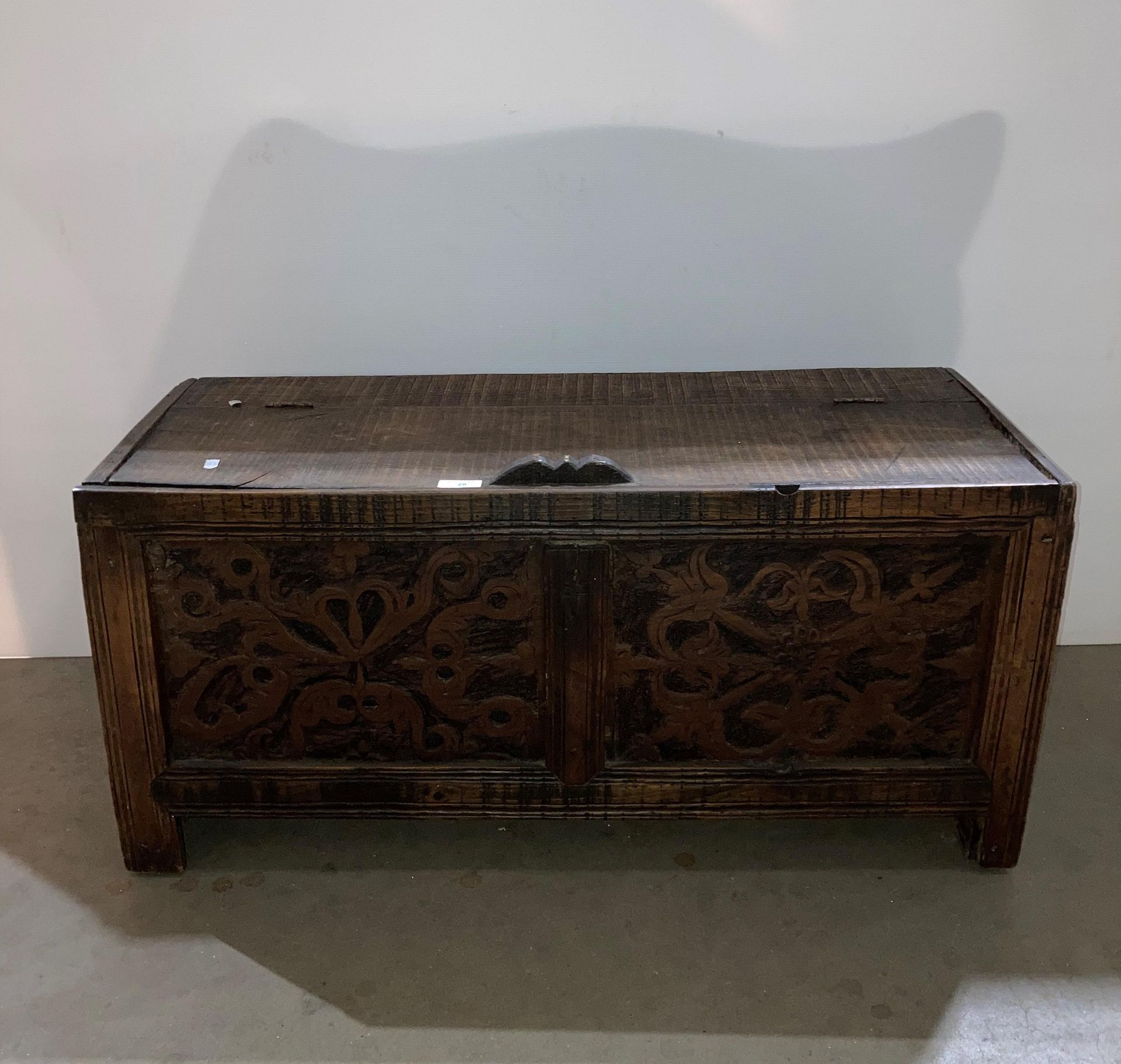 Rustic oak carved front lift top coffer,