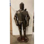 Metal reproduction full suit of armour on a mahogany frame with base,