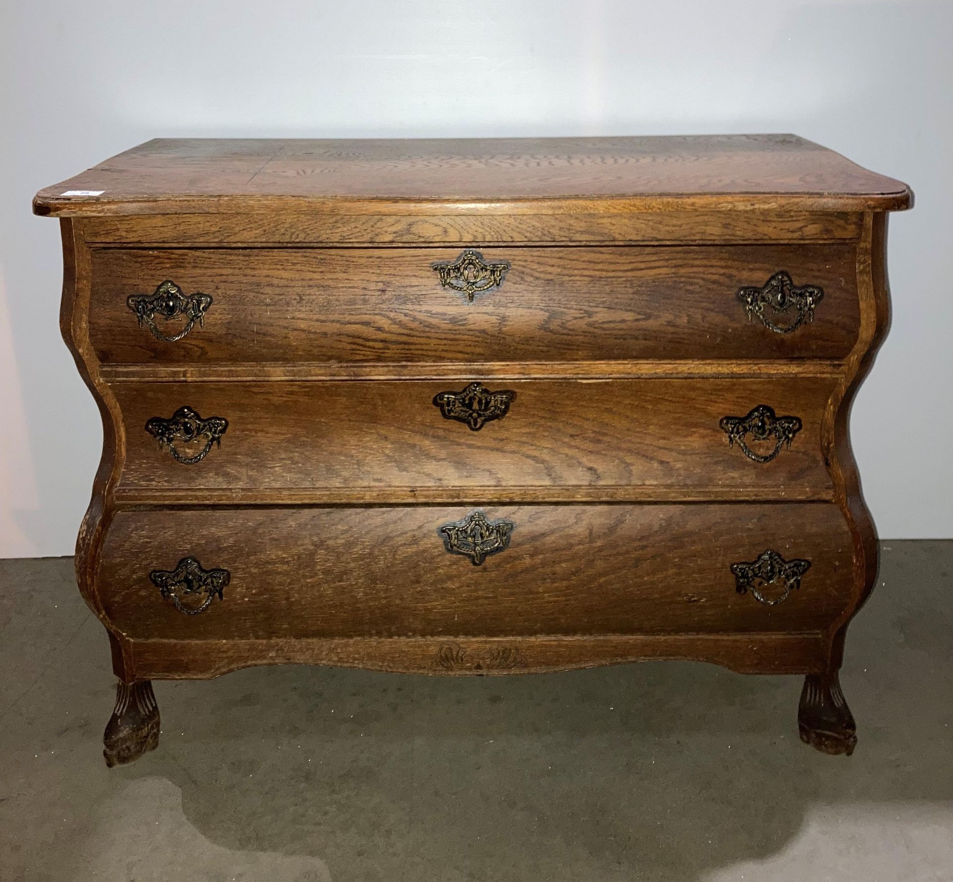 Oak shaped three drawer chest of drawers,