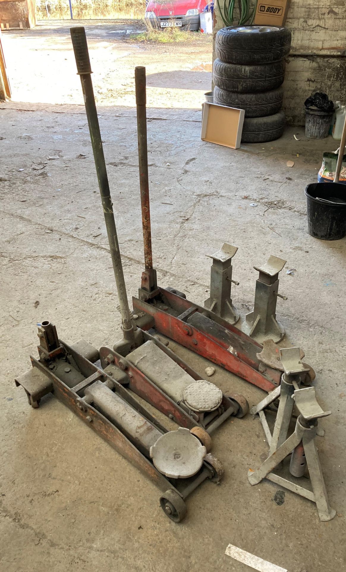 Three assorted large trolley jacks (one spares and repairs) and two pairs of assorted axle stands