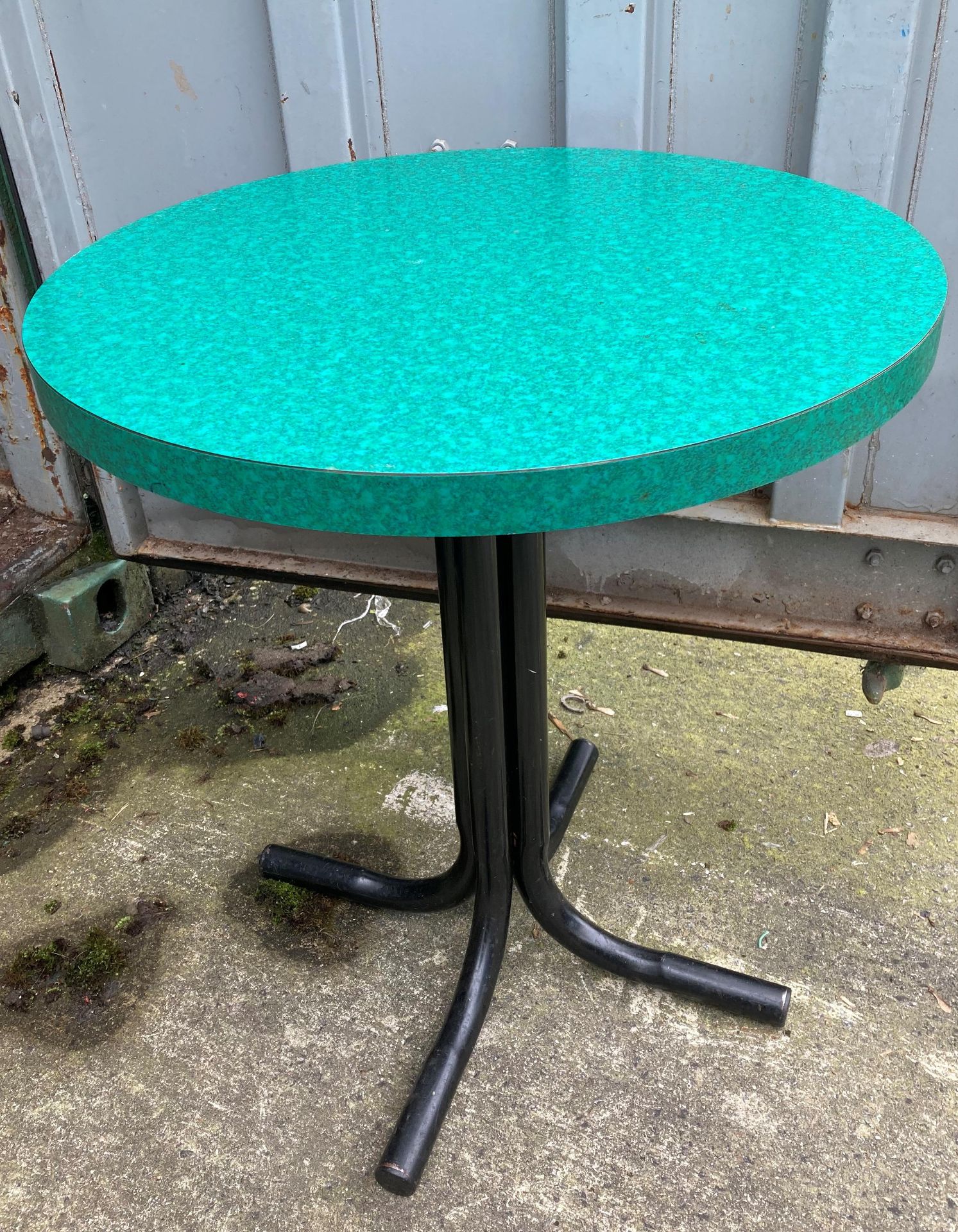 Four metal framed circular pub tables with green formica tops,