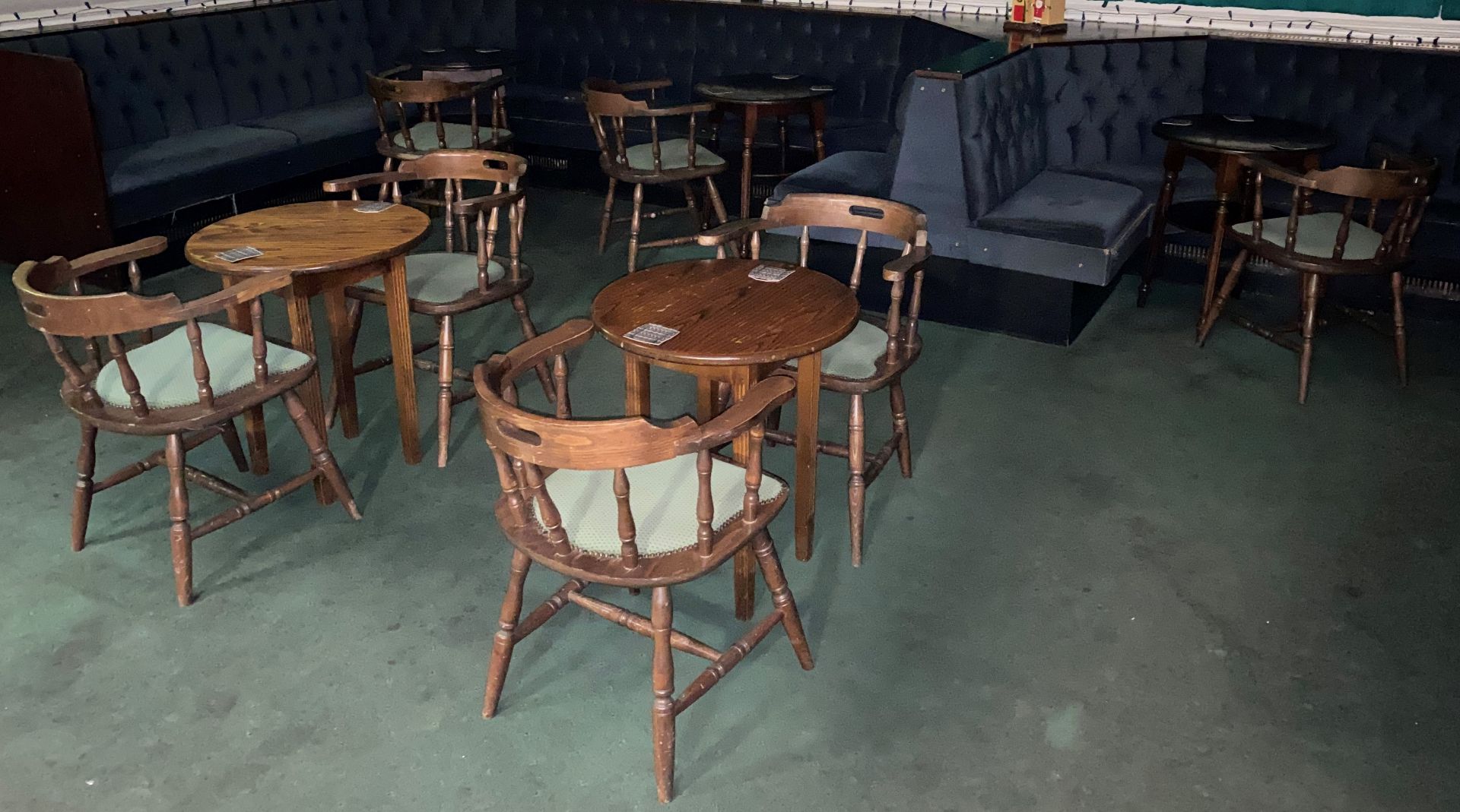 13 x Wooden bar chairs with green cloth upholstry and 8 assorted circular wooden bar tables.