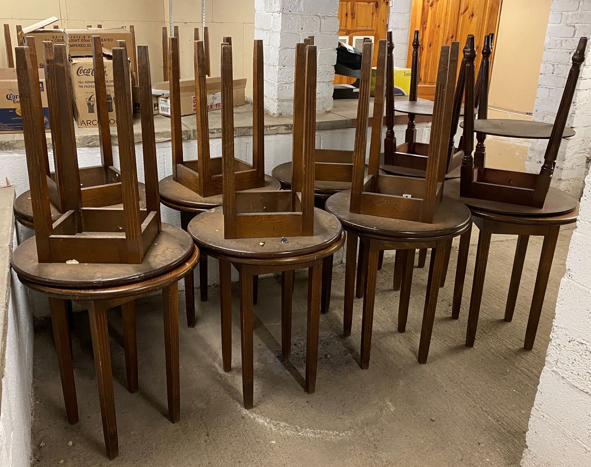 16 x Circular wooden bar tables. Located in the basement.