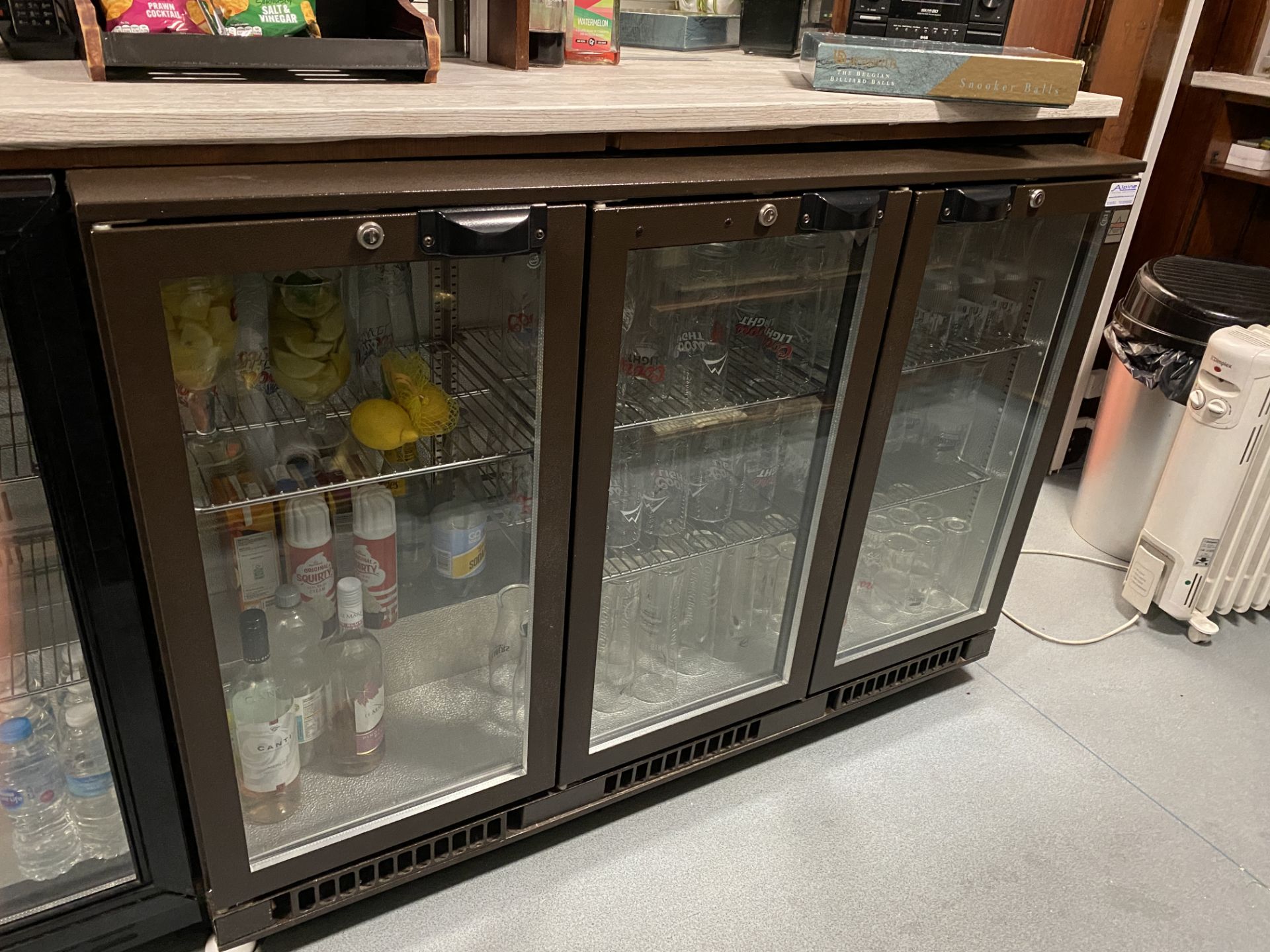 Osborne undercounter three door glass fronted bottle fridge.