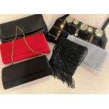 A collection of evening/party bags including red and black satin-feel material clutch bags with