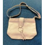 Nathalie Andersen baby pink cross body bag with buckle fastening and tasseled detailing with