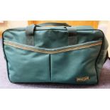 A large Vanguard travel/carry-on bag in forest green with yellow trip and multiple zipper